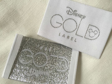 Corte frío tejido doblez de las etiquetas de la ropa del extremo de Bage del oro de Disney/corte del calor